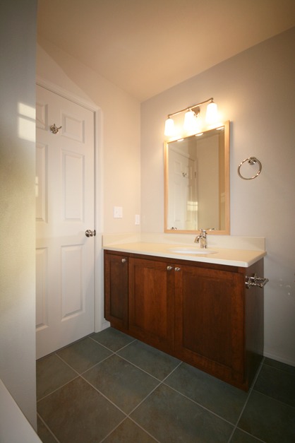 red cherry vanity cabinet, slate green porcelain floor tile