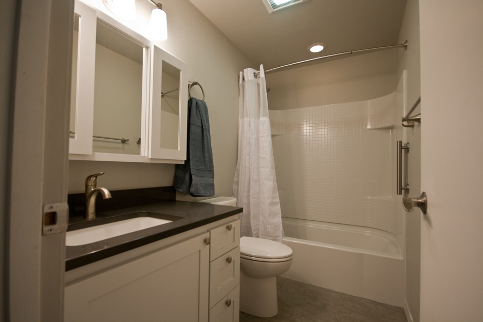 New bathroom remodel with custom white medicine cabinet, acrylic tub/shower unit