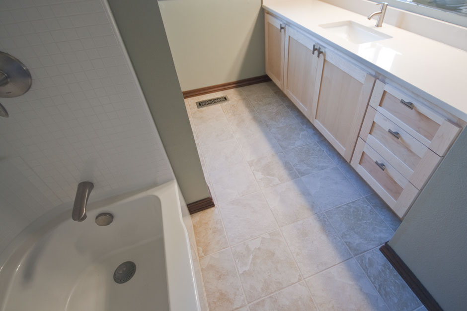 straight-forward bathroom remodel with tile floor, acrylic tub/ shower