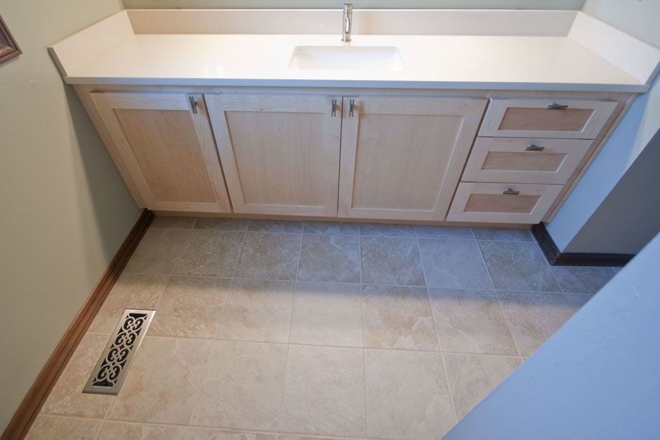 New maple bathroom vanity with cream quartz counter, beige tile floor