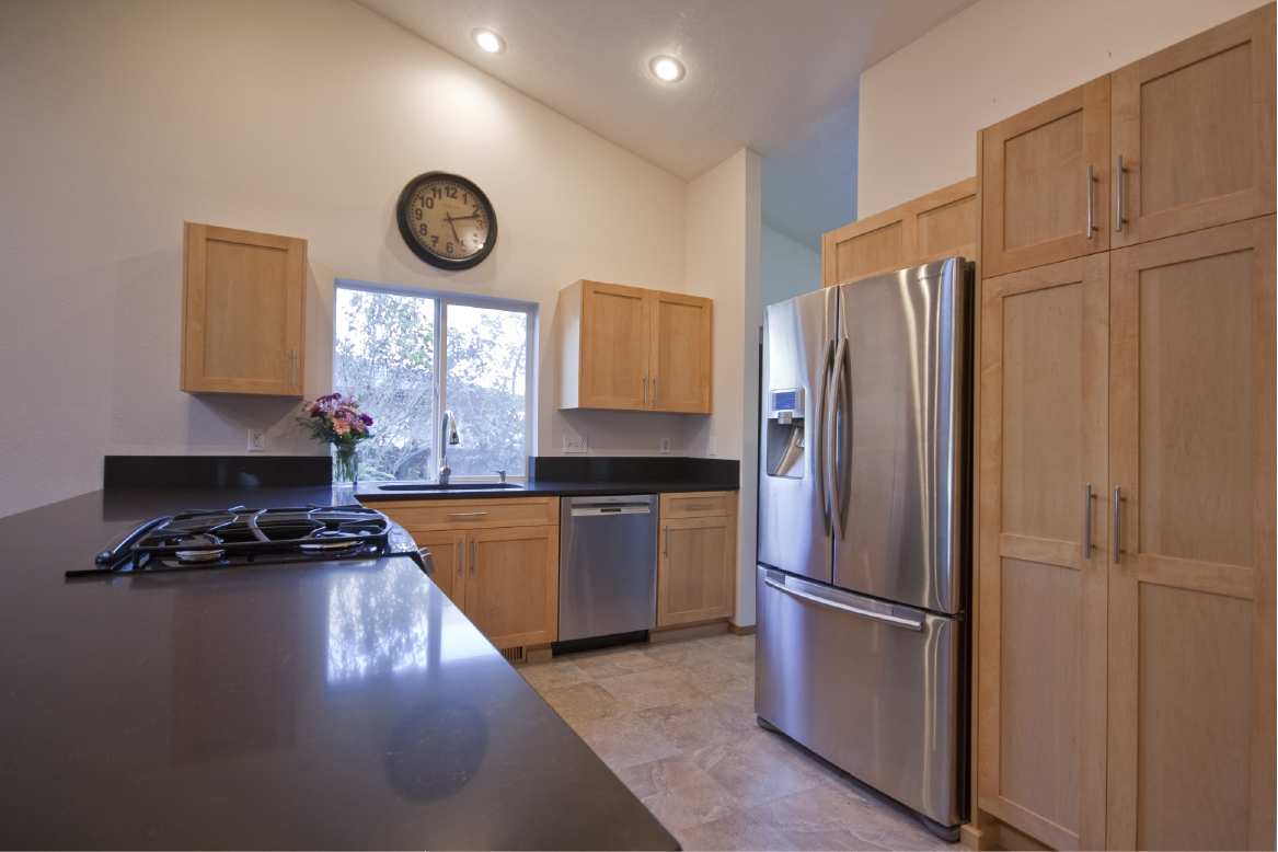 Stained maple frameless kitchen cabinets