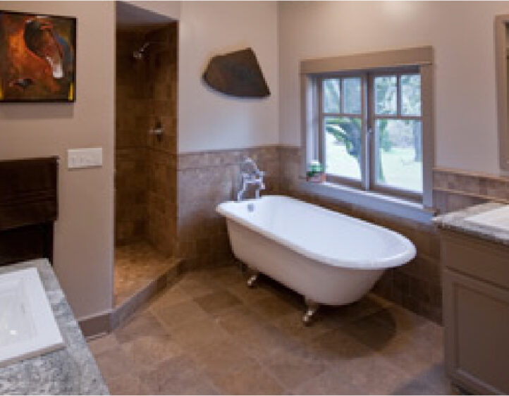 Clawfoot bathtub and travertine