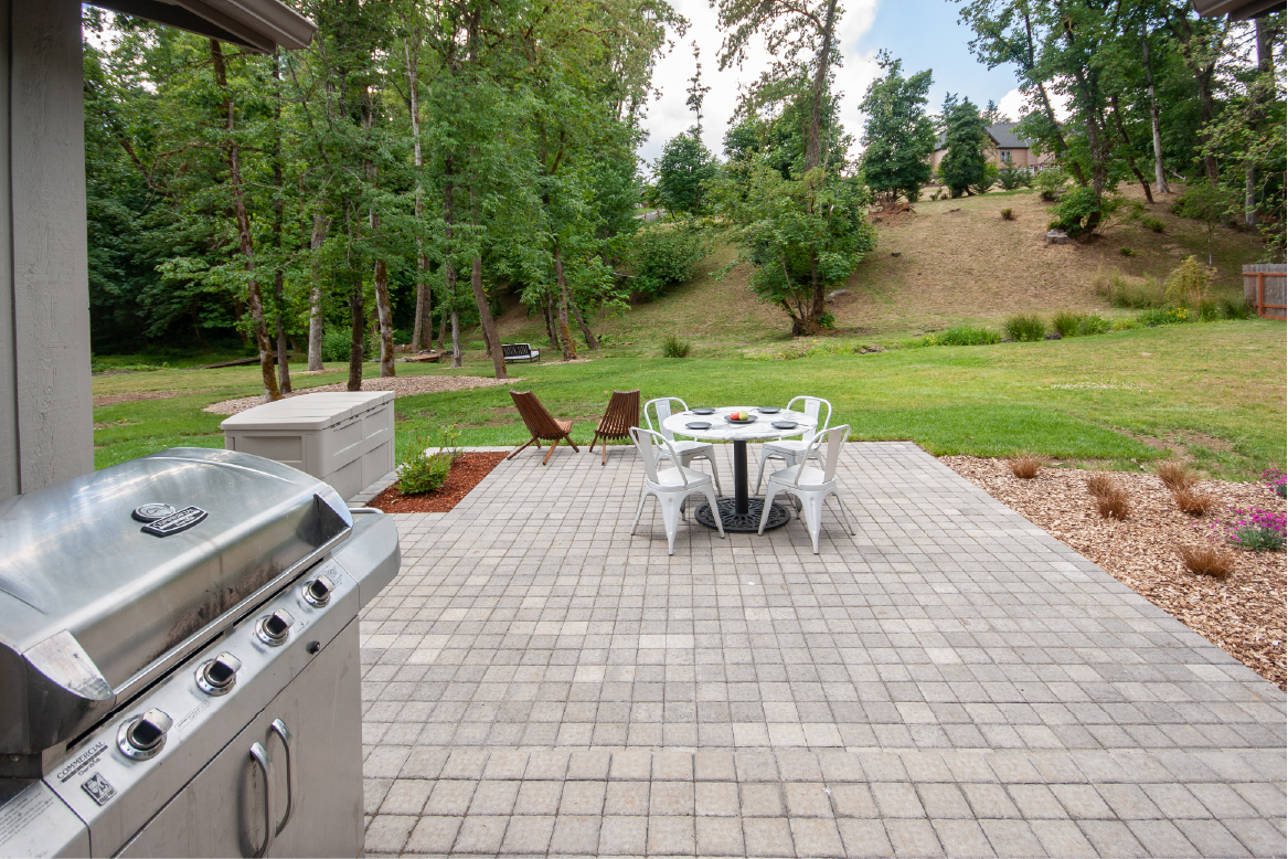 paver patio with backyard creek