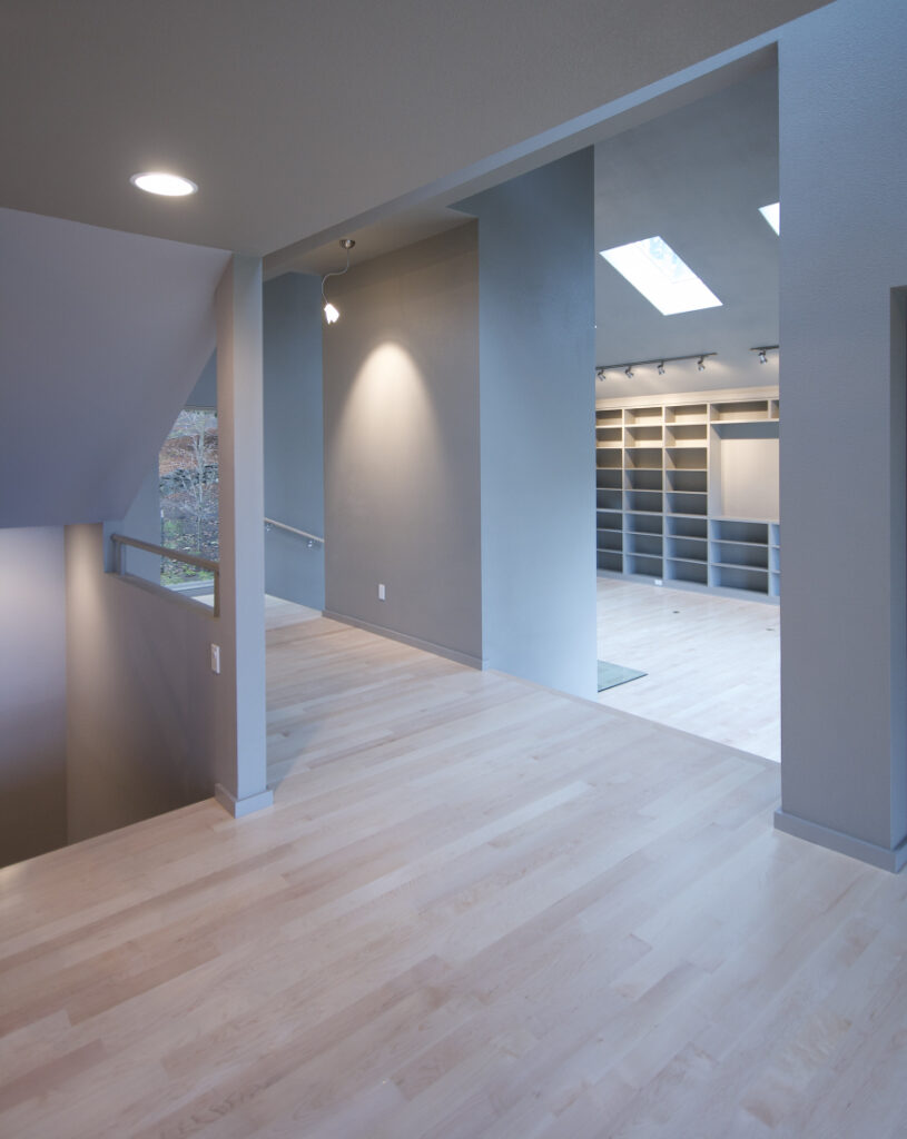 Hallway art display wall and living room bookcases