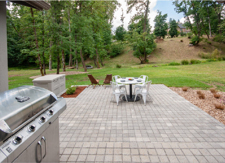 paver patio with backyard creek