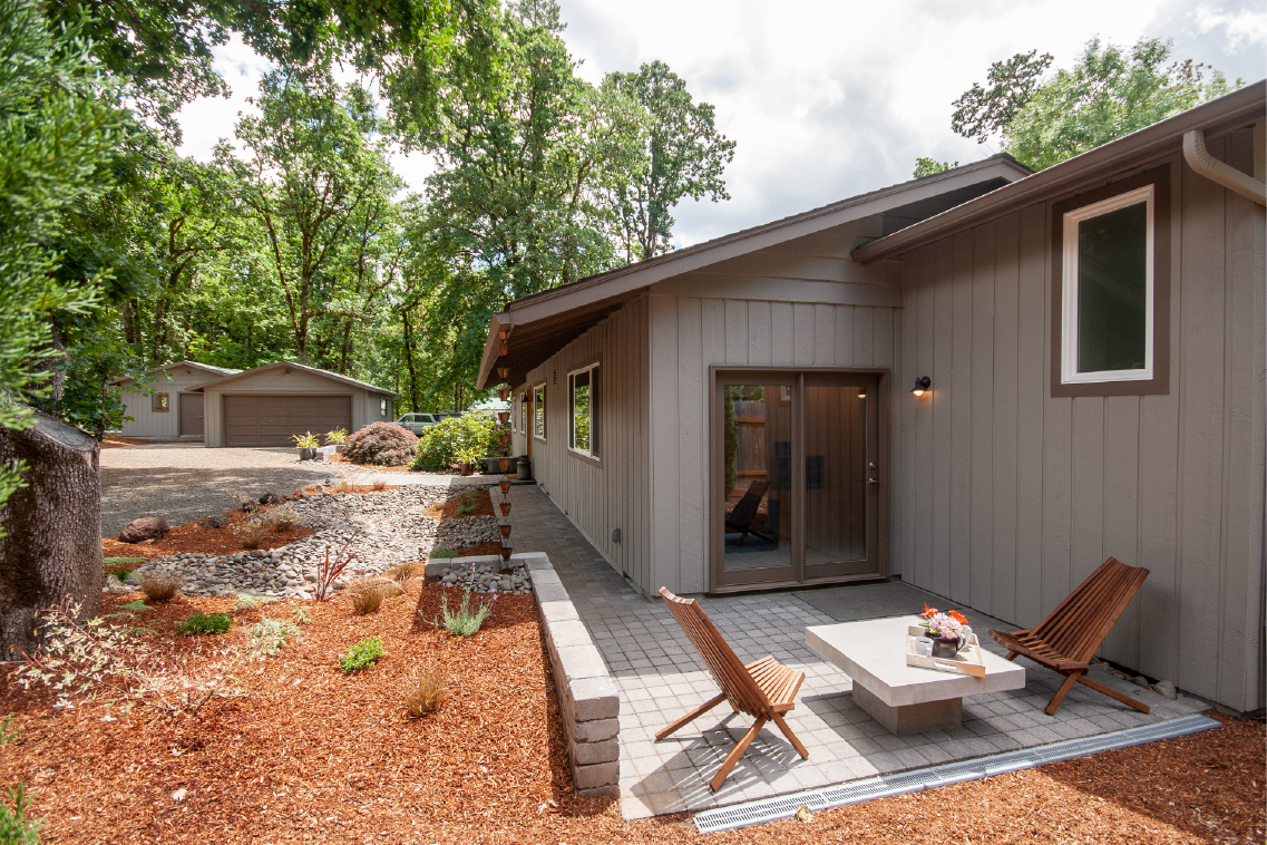side yard paver patio with short tumbled block retaining wall