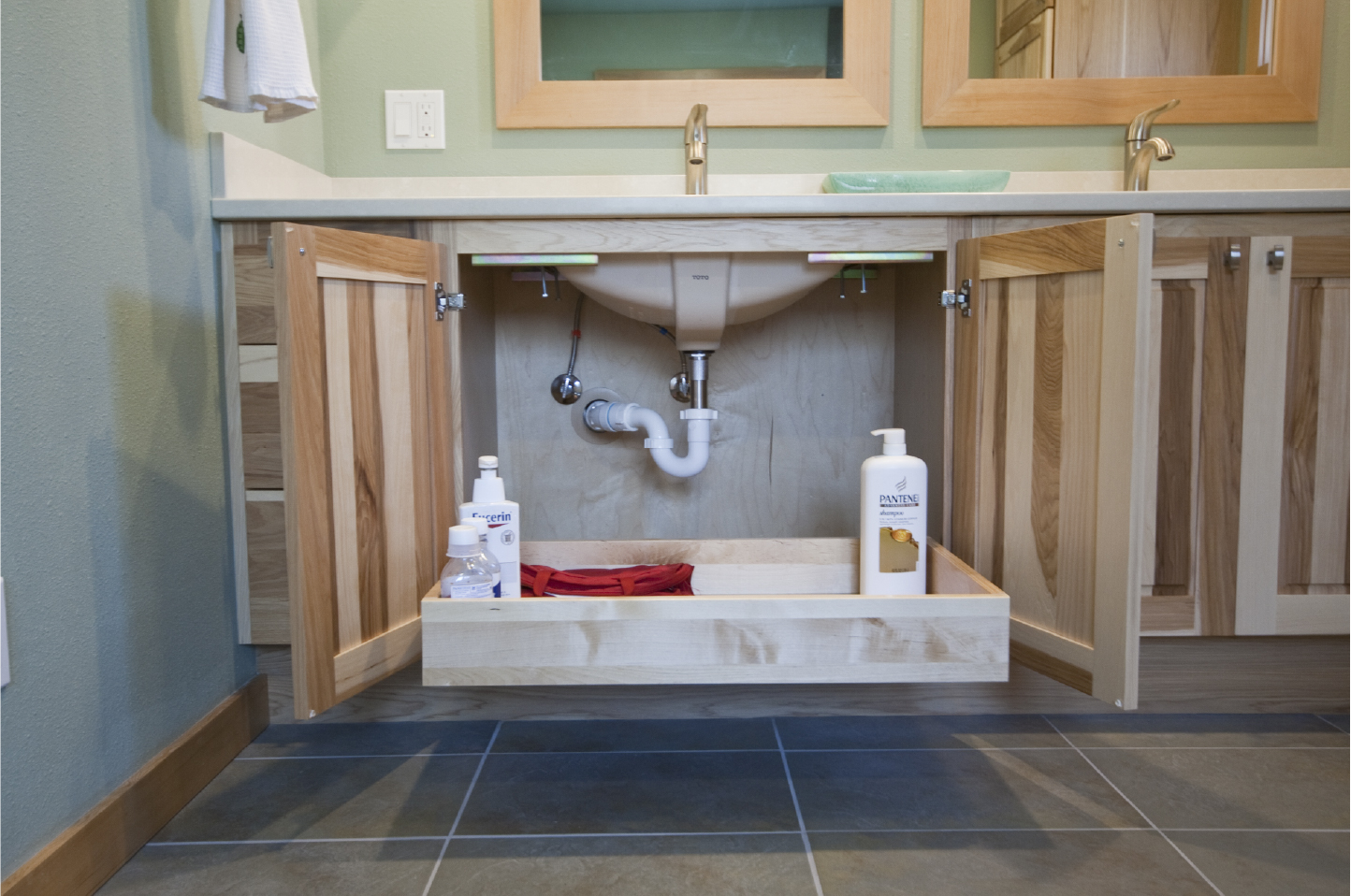 Pull out drawer in vanity sink base cabinet