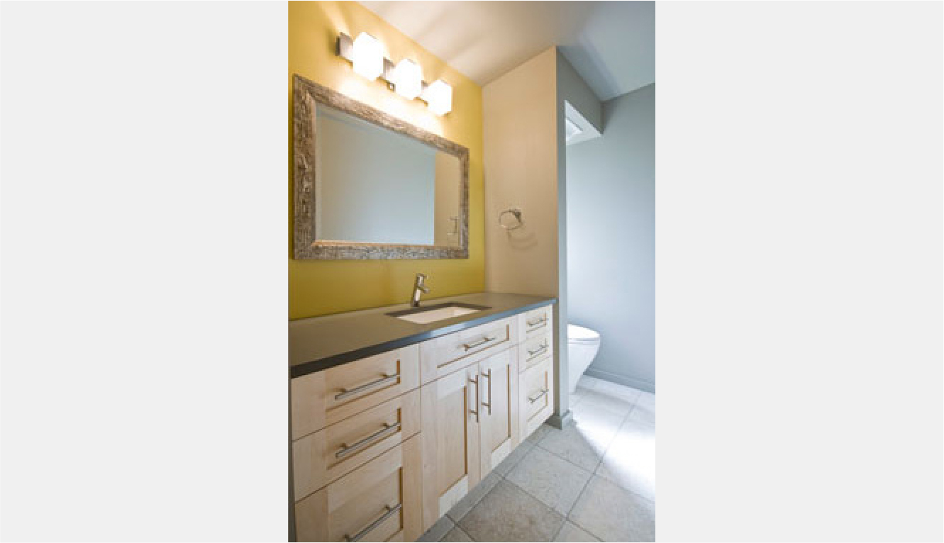 Yellow accent wall behind vanity