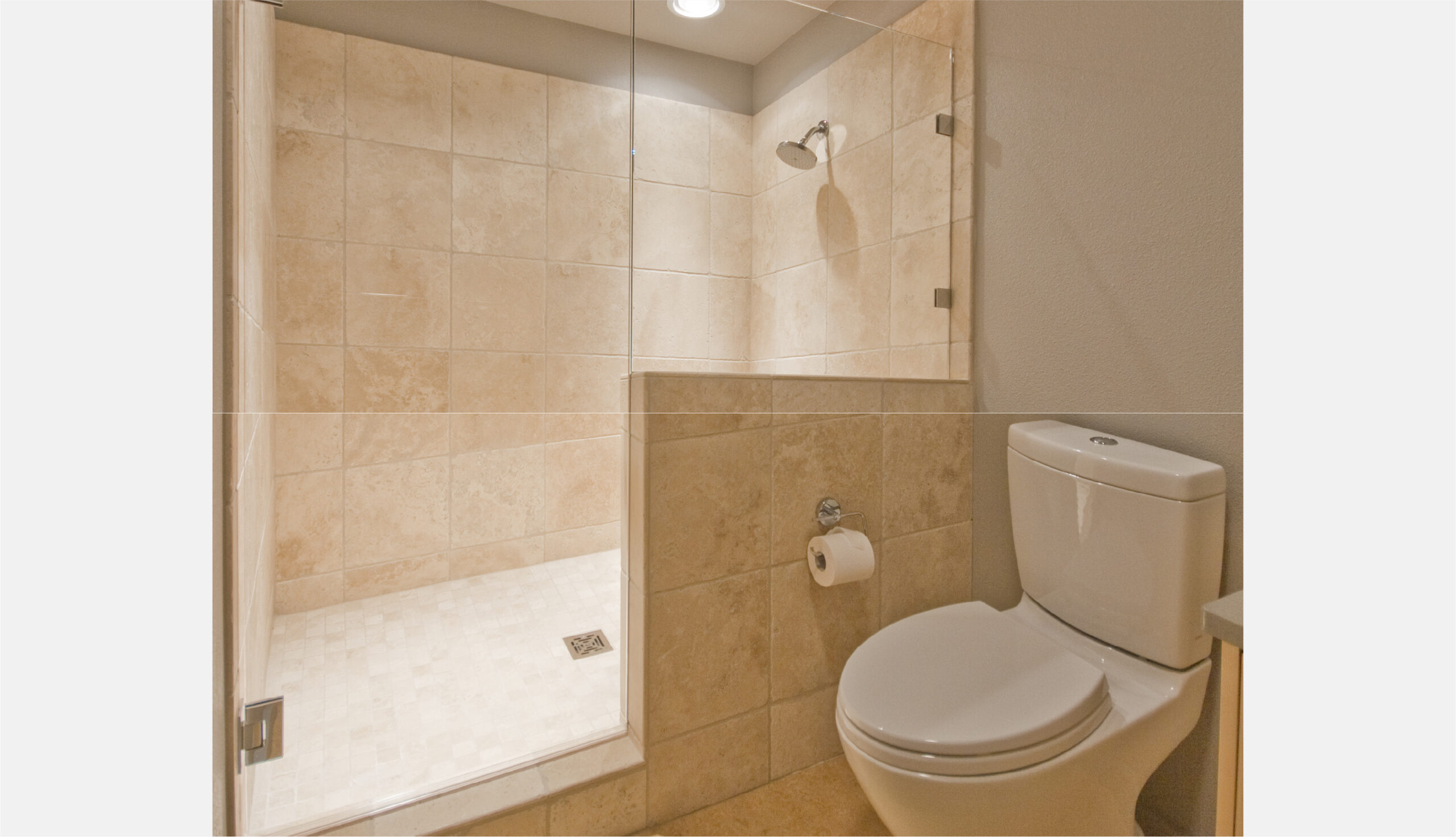Basement bathroom large travertine shower and low flush toilet