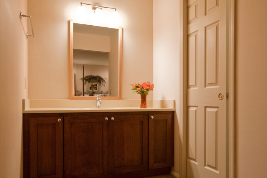 Re-made bathroom vanity area with custom CVG fir mirror frame.