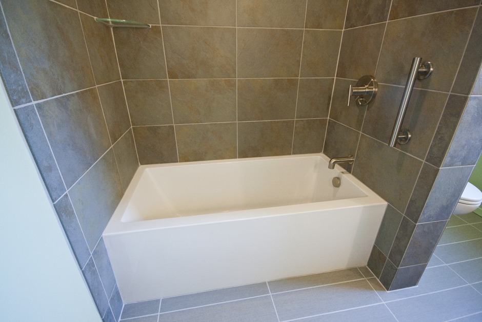 We swapped a tiny shower for a nice tub and tiled surround.