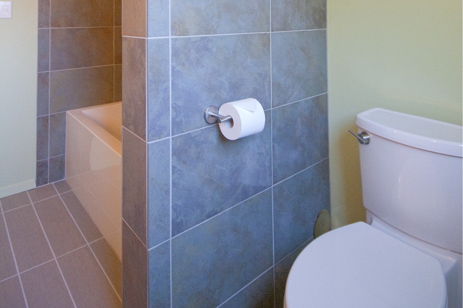 We rotated this toilet 90 degrees and tiled the adjacent wall for a luxury touch.