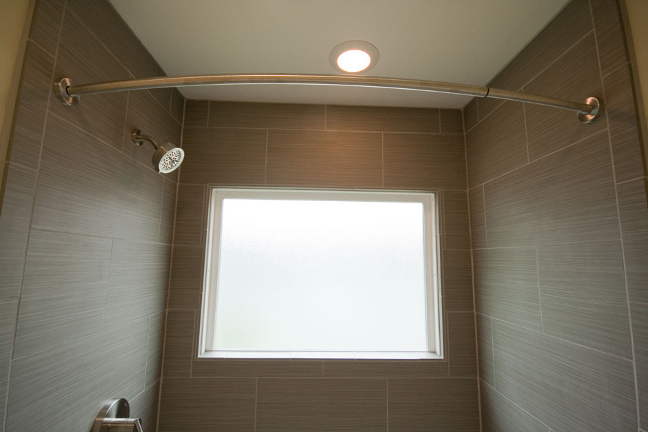 Fully waterproofed vinyl obscure-glass window in shower wall.
