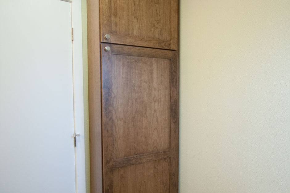 Very tall brown cherry medicine cabinet.
