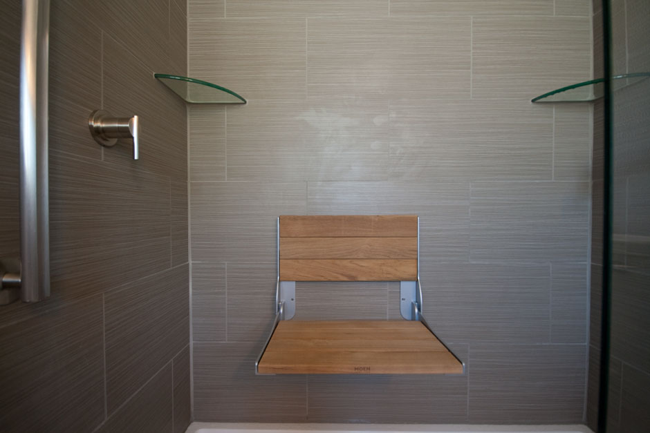 folding teak shower seat in the down position