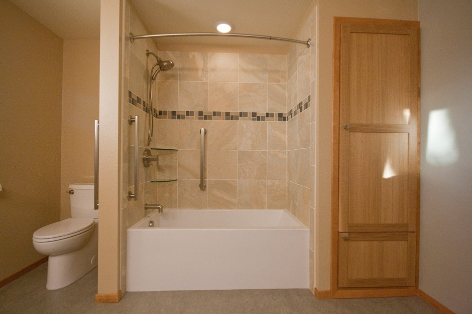 white oak tall cabinet and tile tub surround, brown Marmoleum flooring