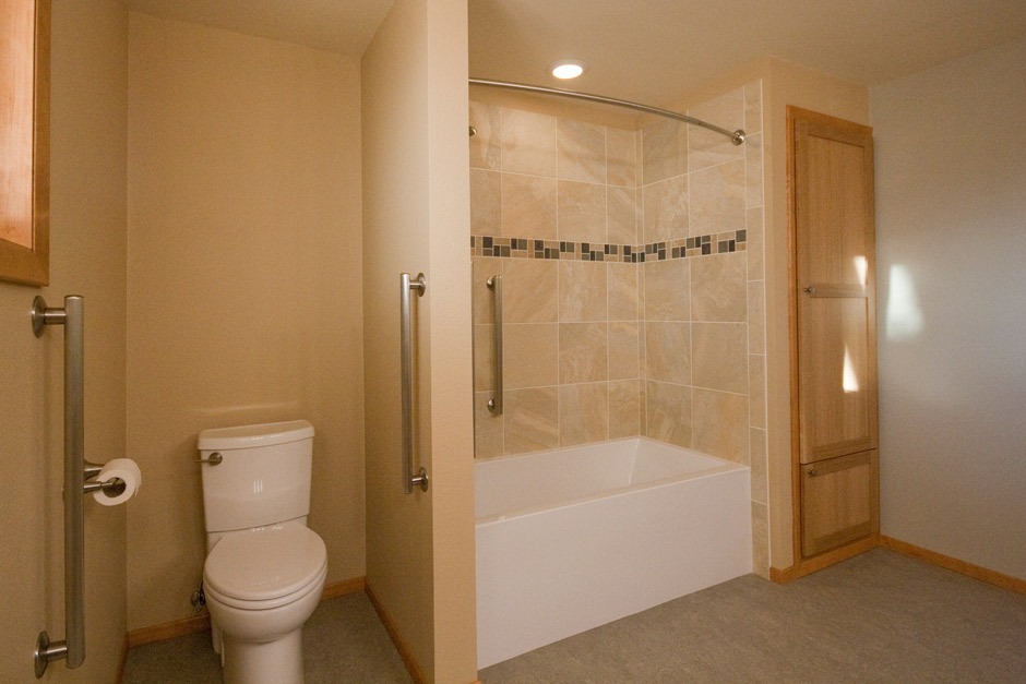 tile accent band and stylish grab bars