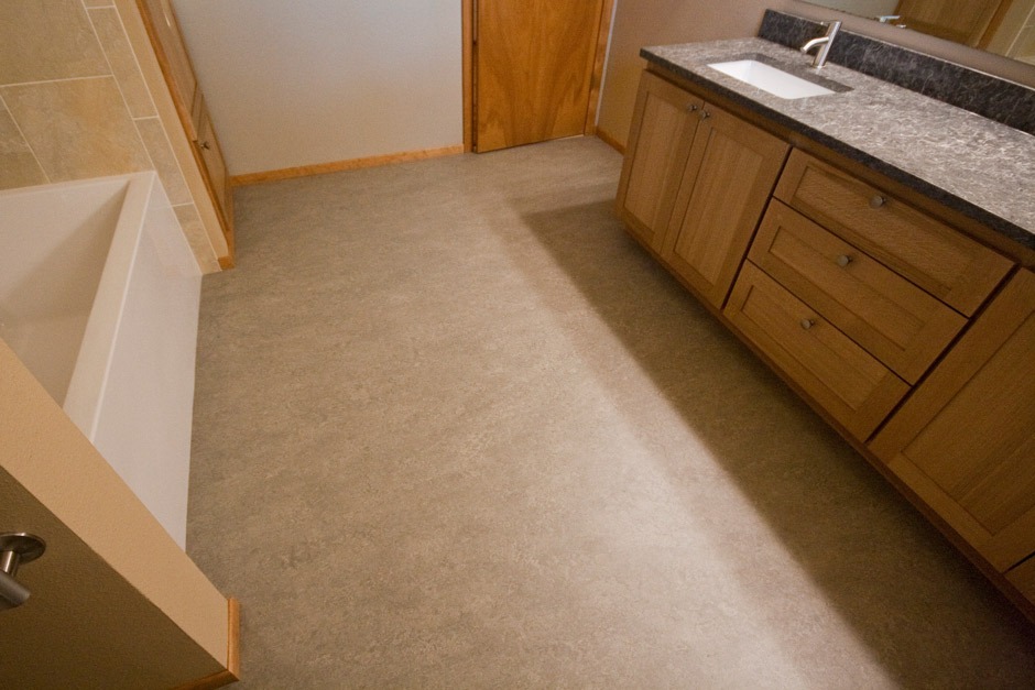 gray-brown Marmoleum sheet flooring in bathroom