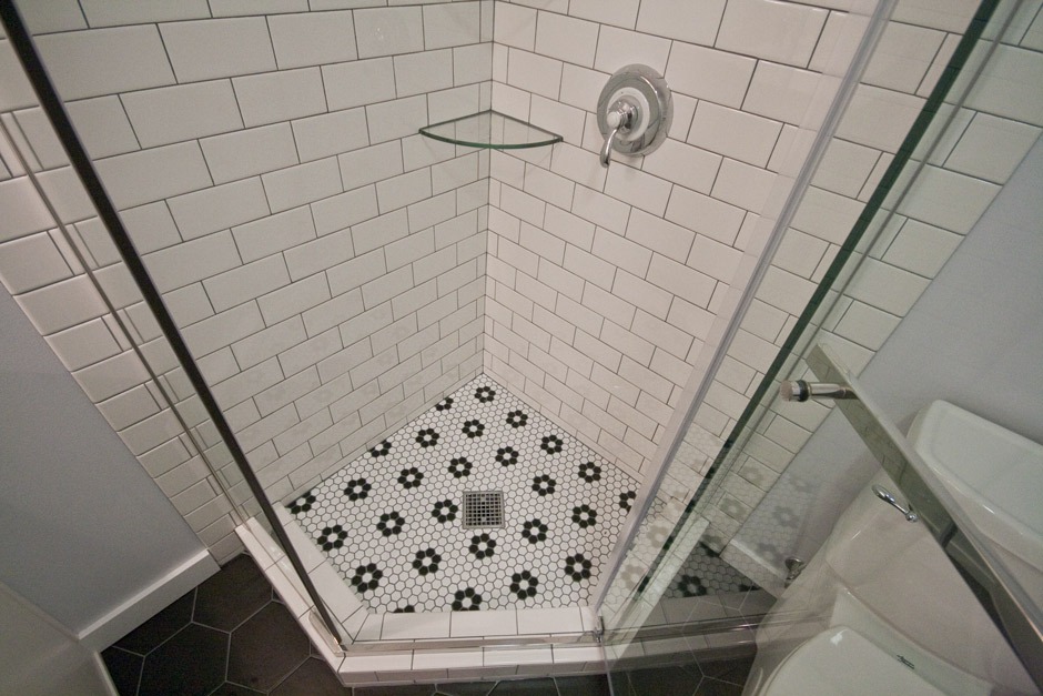 subway tile shower with black & white hex tile floor