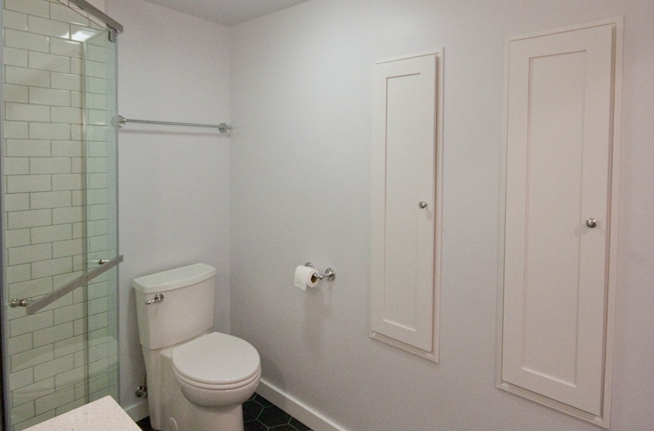 bath remodel with white cabinets recessed in wall