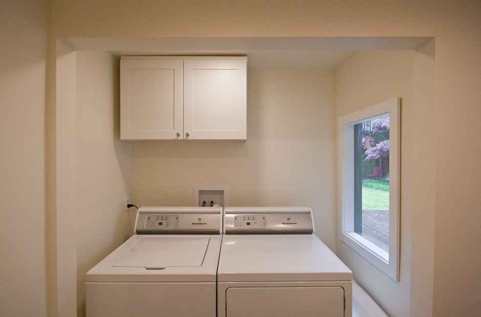 laundry room remodel with window and wall cabinet