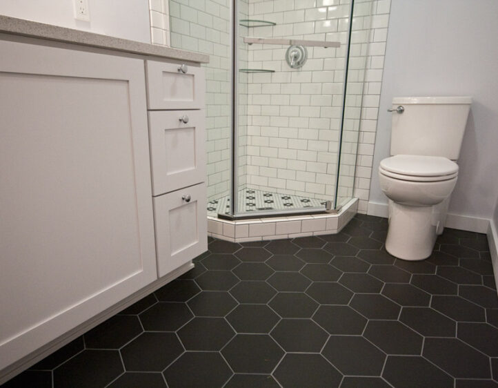 cool matte black hex tile flooring in bathroom