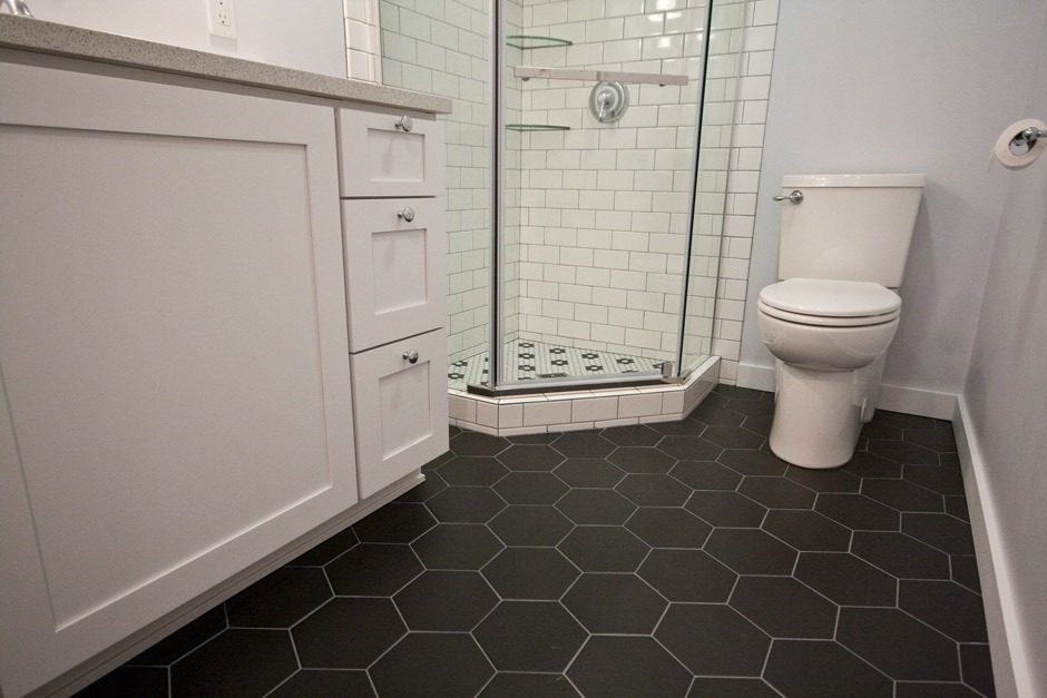 cool matte black hex tile flooring in bathroom