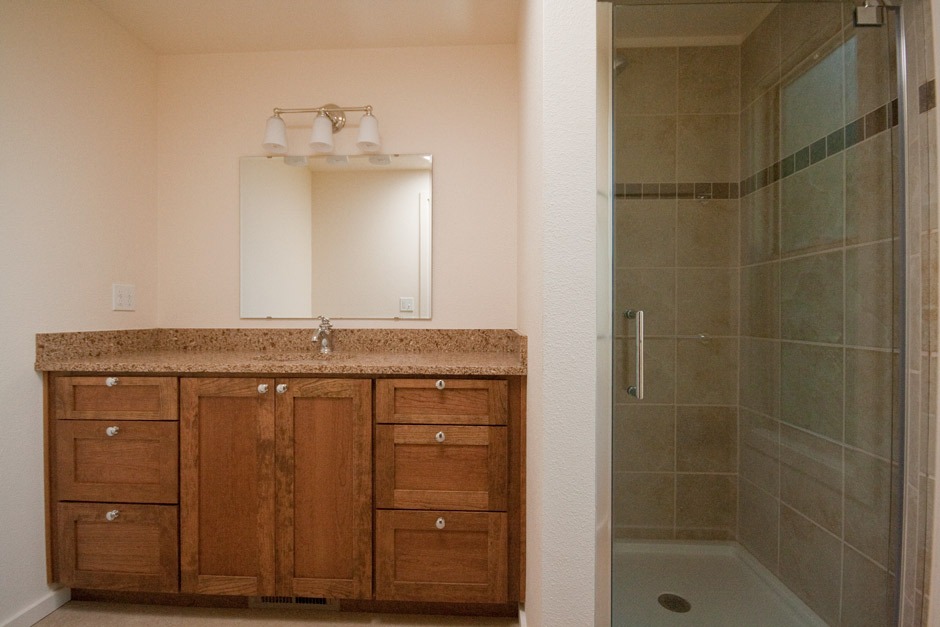 re-built bathroom with brown cherry vanity cabinets.