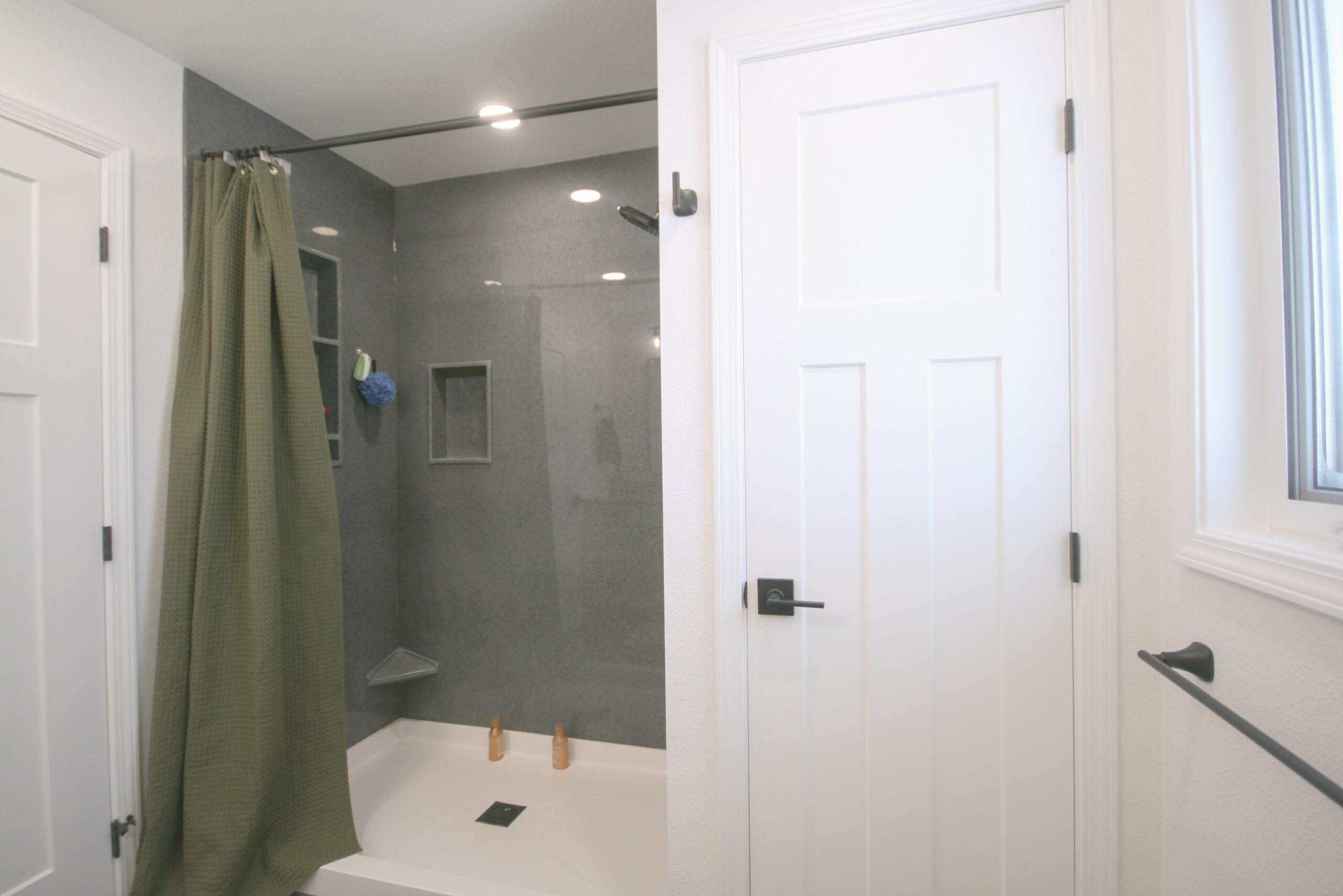 Bathroom remodel with well-lit large shower and closet.