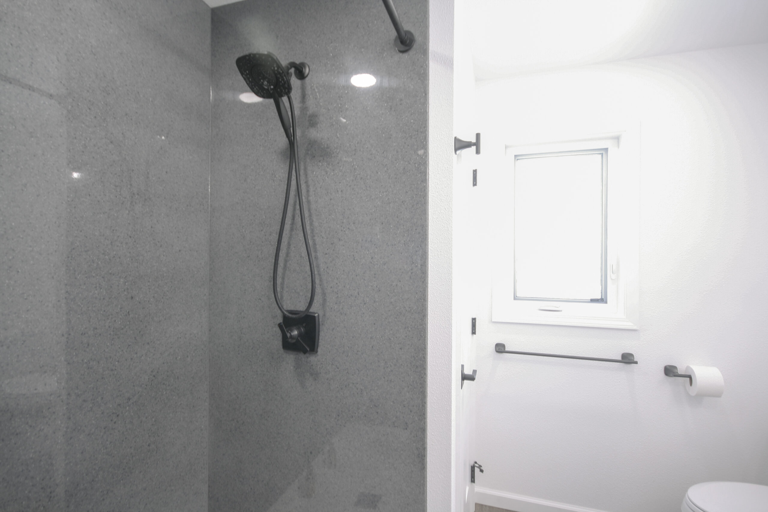 Bathroom remodel featuring a large, modern shower that was converted from the old tub.